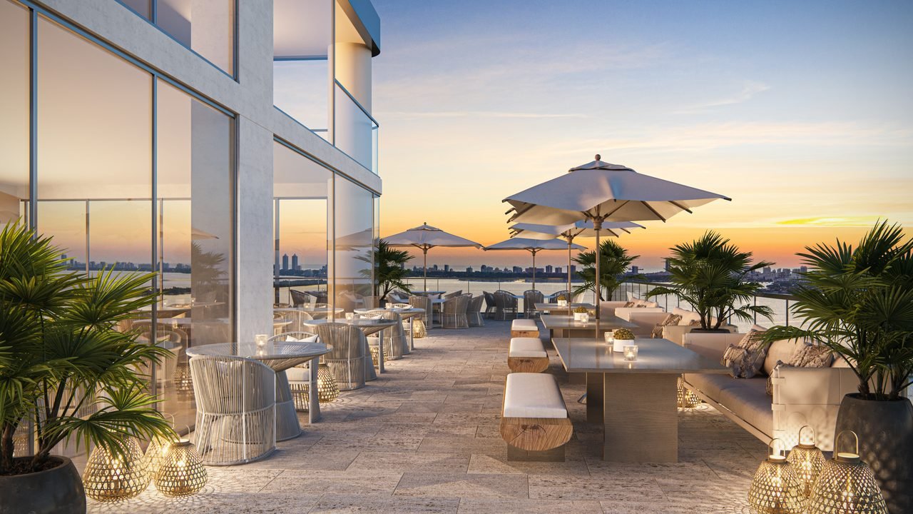 Aria Reserve Miami — bay-level outdoor terrace with waterfront dining at sunset (artist's rendering)