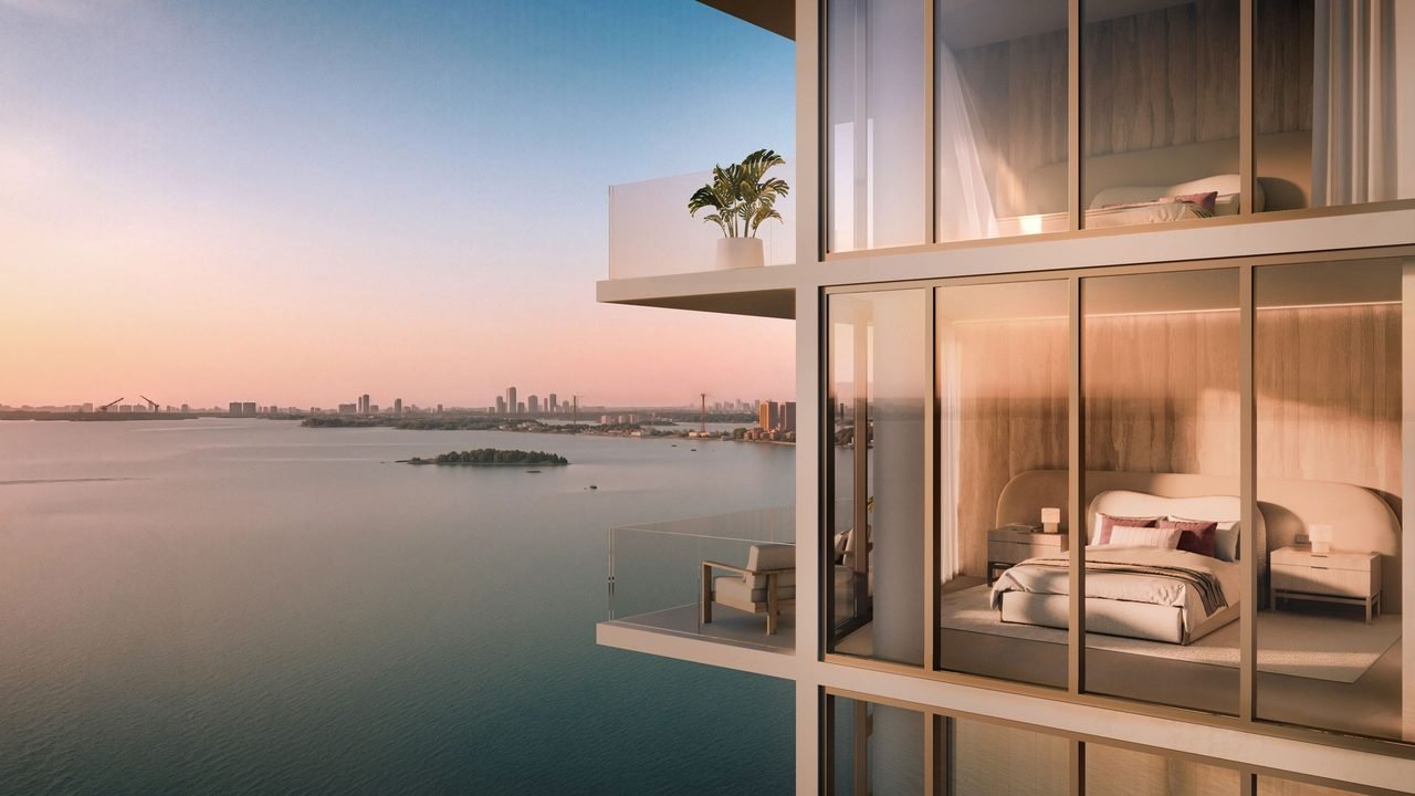 The Cove Residences — terrace view overlooking Biscayne Bay and Miami skyline at sunset (artist's rendering)