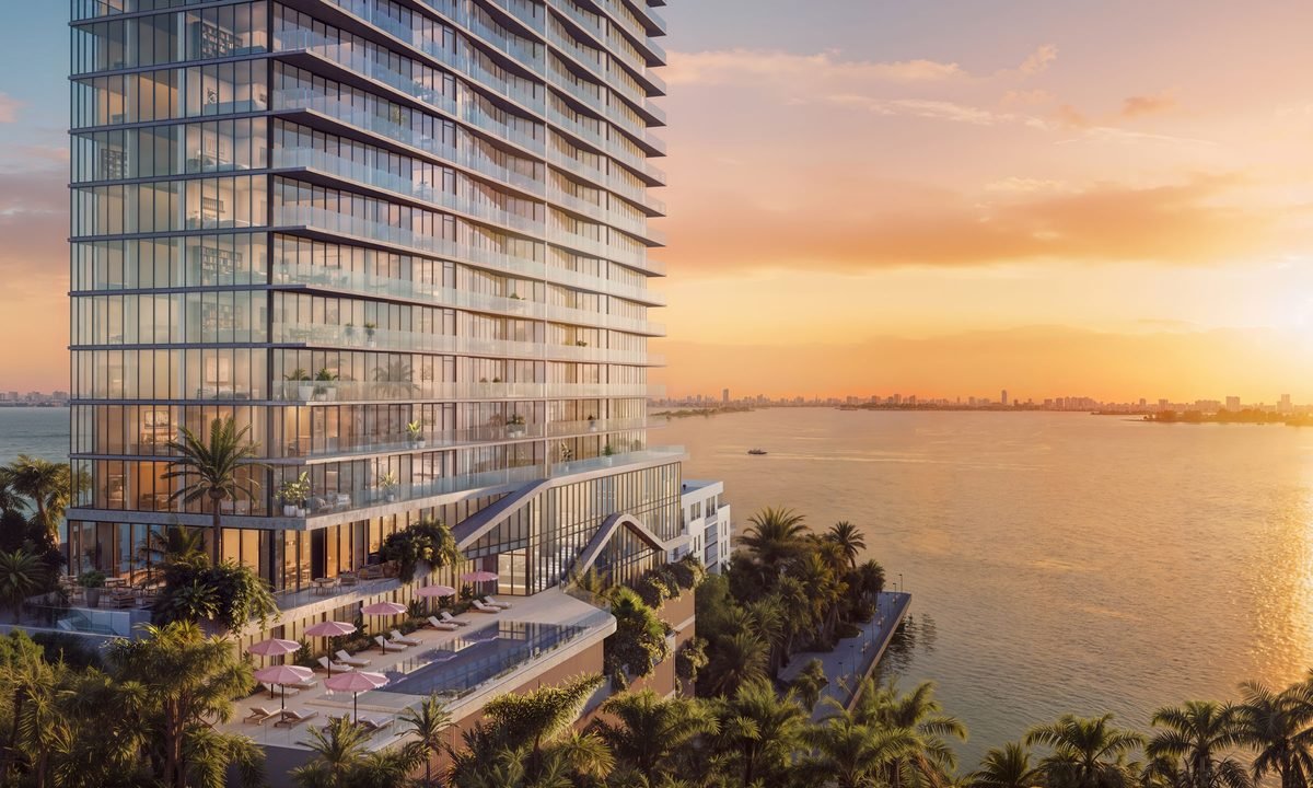 The Cove Residences — building exterior with bayfront pool terrace and Biscayne Bay at sunset, Edgewater Miami (artist's rendering)
