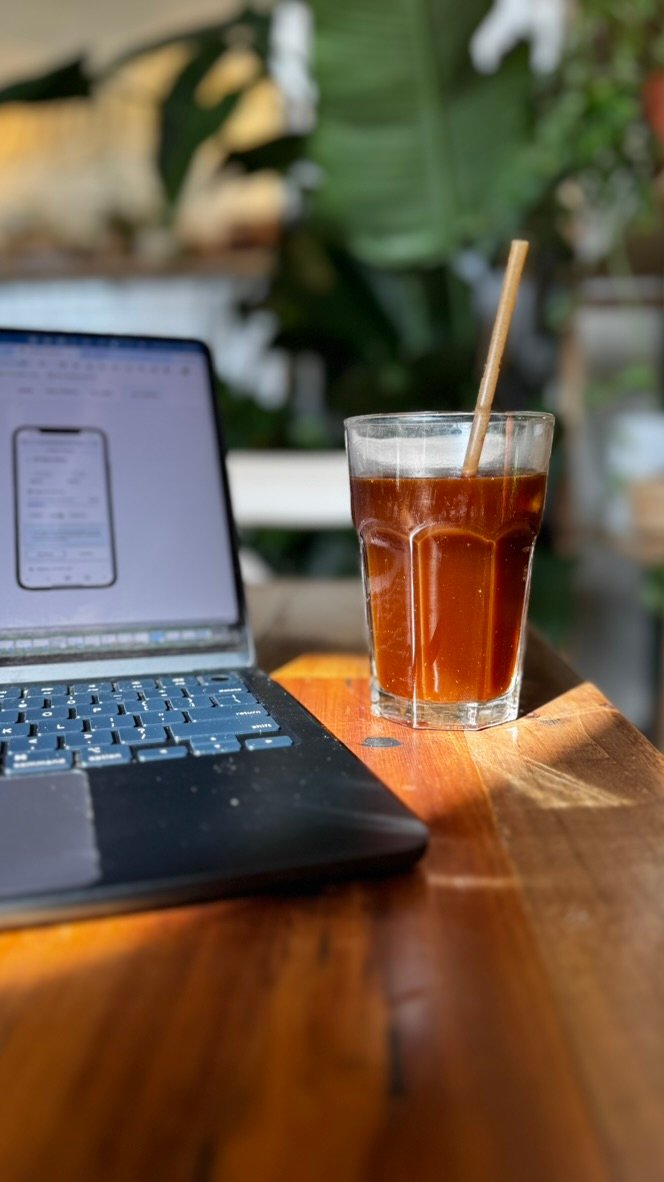 Coffee and laptop at Magdalena Coffee and Houseplants in Edgewater Miami