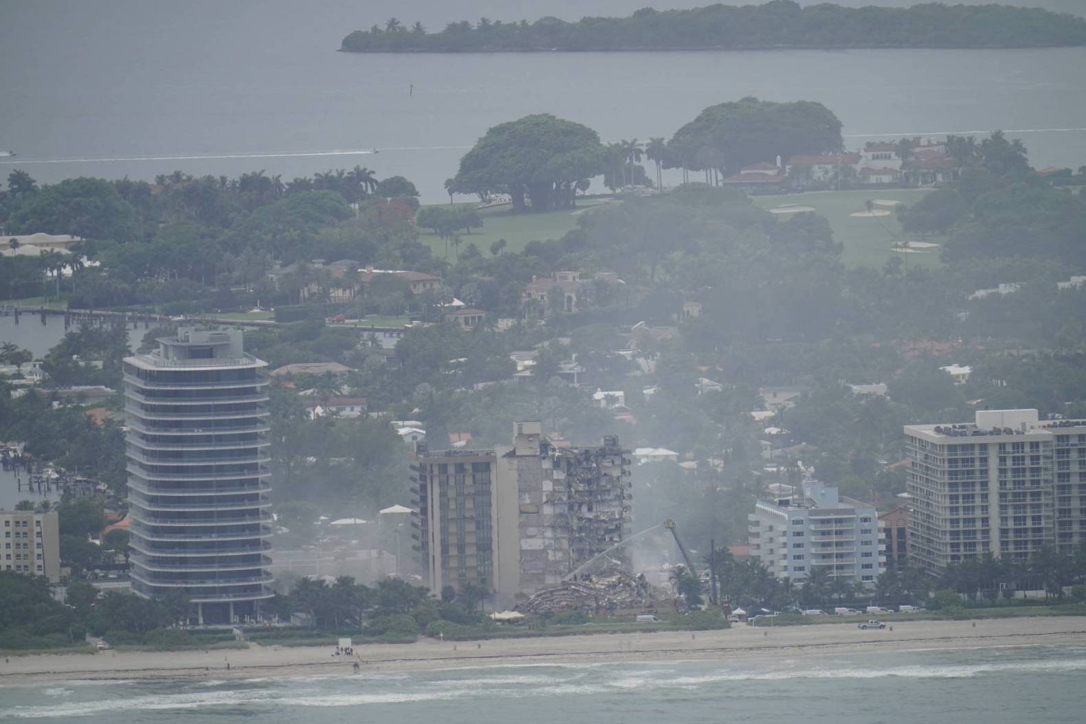 A Florida condo building under dark, stormy skies, representing the current crisis.