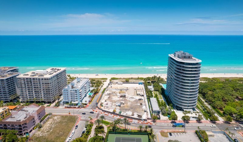 Aerial view of beachfront buildings and construction site beside the ocean in Surfside, Miami, South Florida, USA.