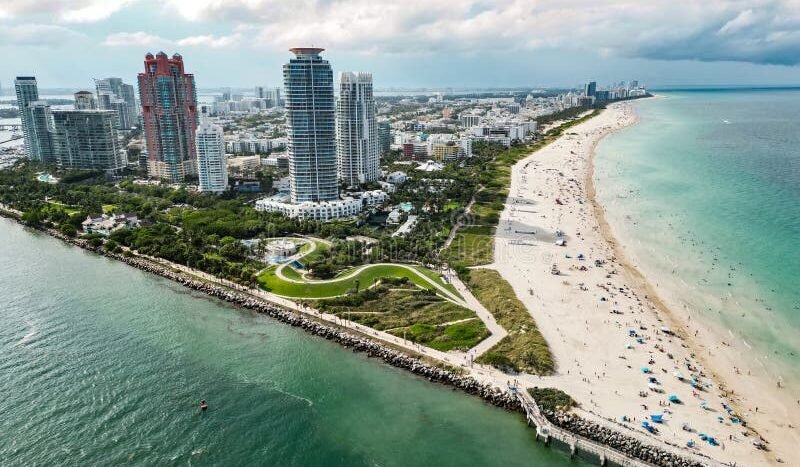 Aerial view of South Beach, Miami, Florida, with skyscrapers, sandy beach, and turquoise ocean. Popular tourist destination.