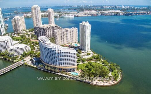 Aerial view of Brickell Key's waterfront skyline, showing luxury condos and Biscayne Bay, Florida, USA.